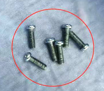 Why does the plating layer of bolts show black spots during salt spray testing?